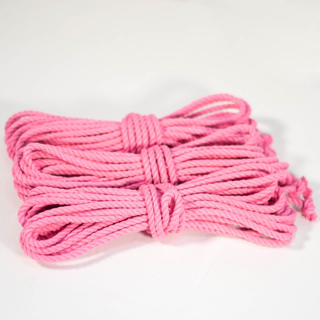 3 coiled pink cotton ropes with knots on the end, displayed on a white background.
