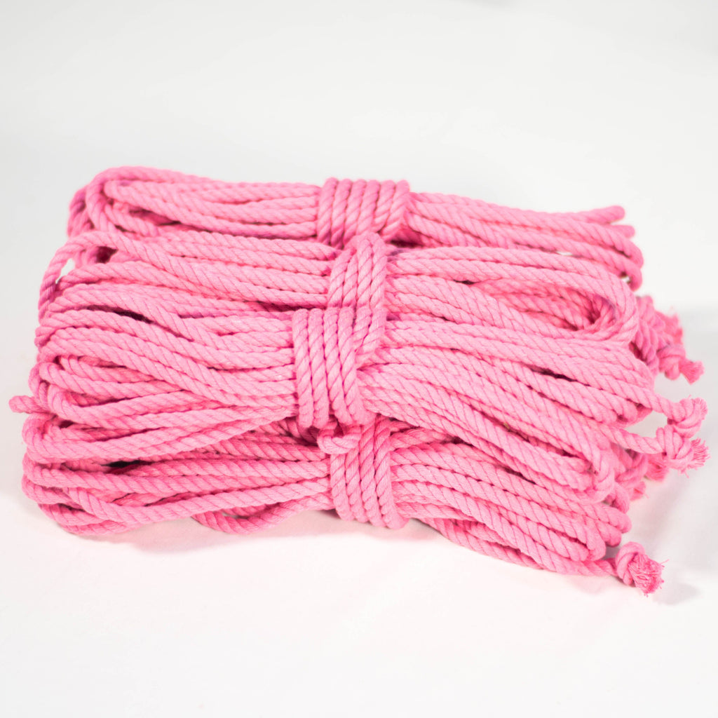 6 coiled pink cotton ropes with knots on the end, displayed on a white background.