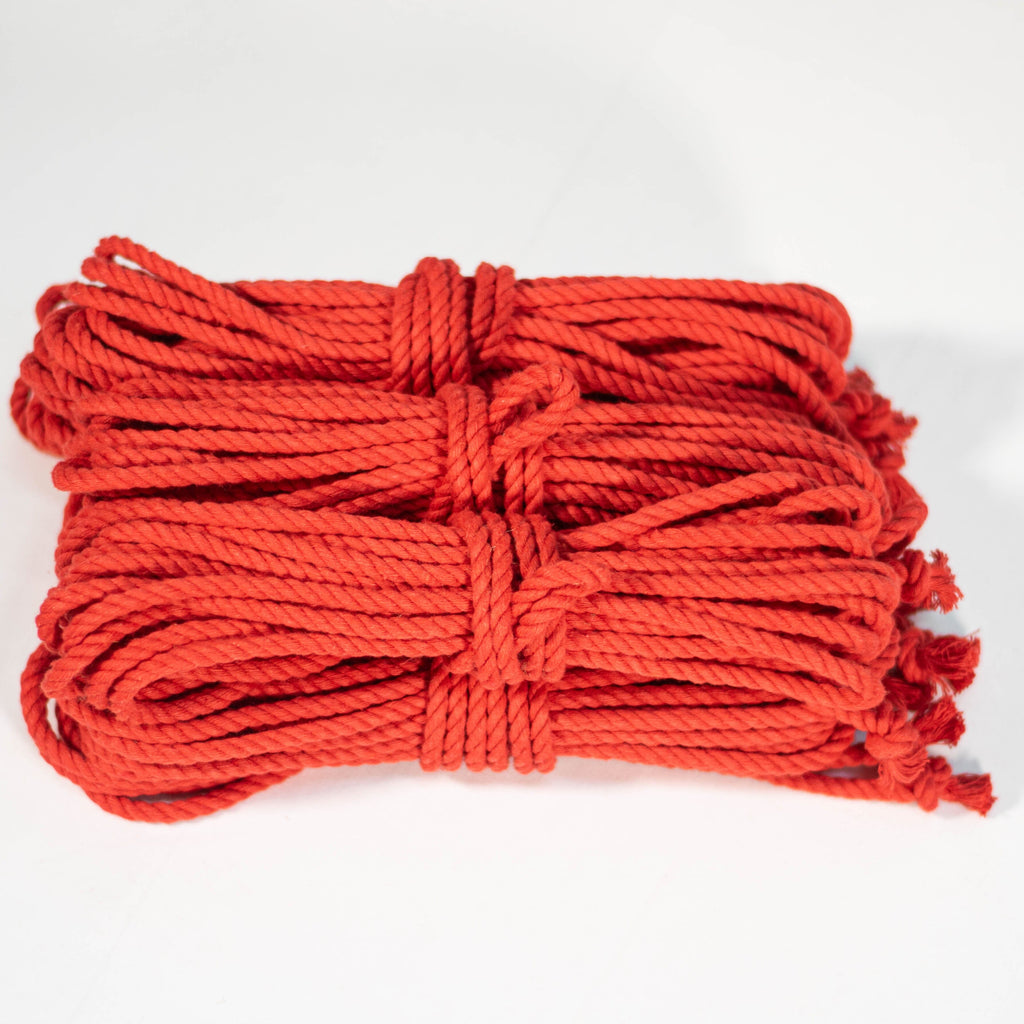 6 coiled red cotton ropes with knots on the end, displayed on a white background.