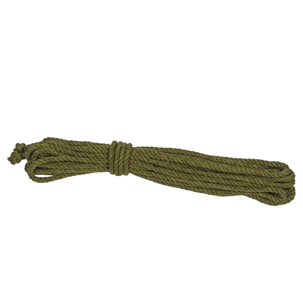 Coiled green cotton rope on a light gray background